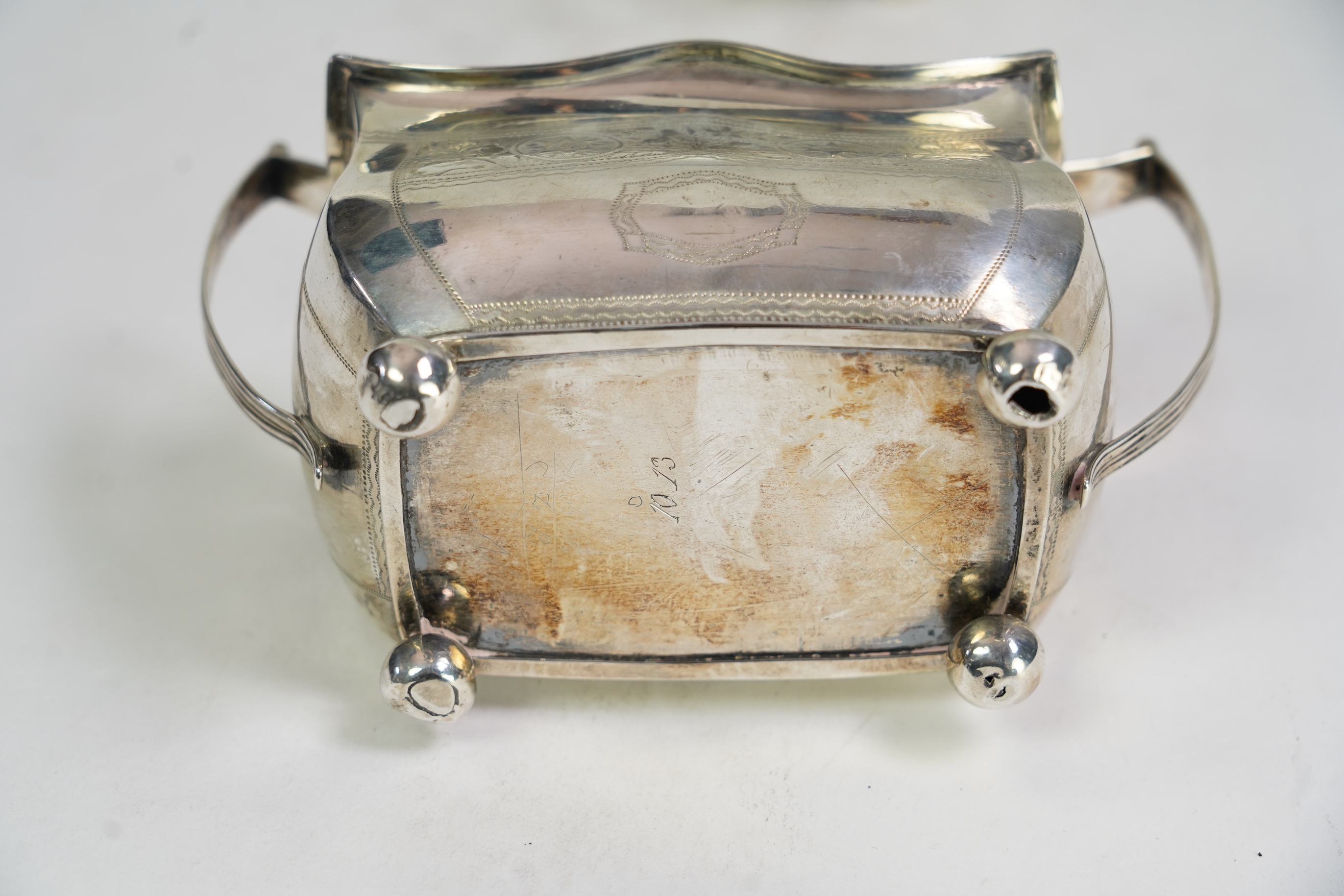 A George III Irish silver two handled sugar bowl, by Richard Sawyer, Dublin, 1808, 18.4cm over handles, with engraved armorial, on four ball feet, together with a similar cream jug, by Daniel Egan, Dublin, 1811, 16.2oz.
